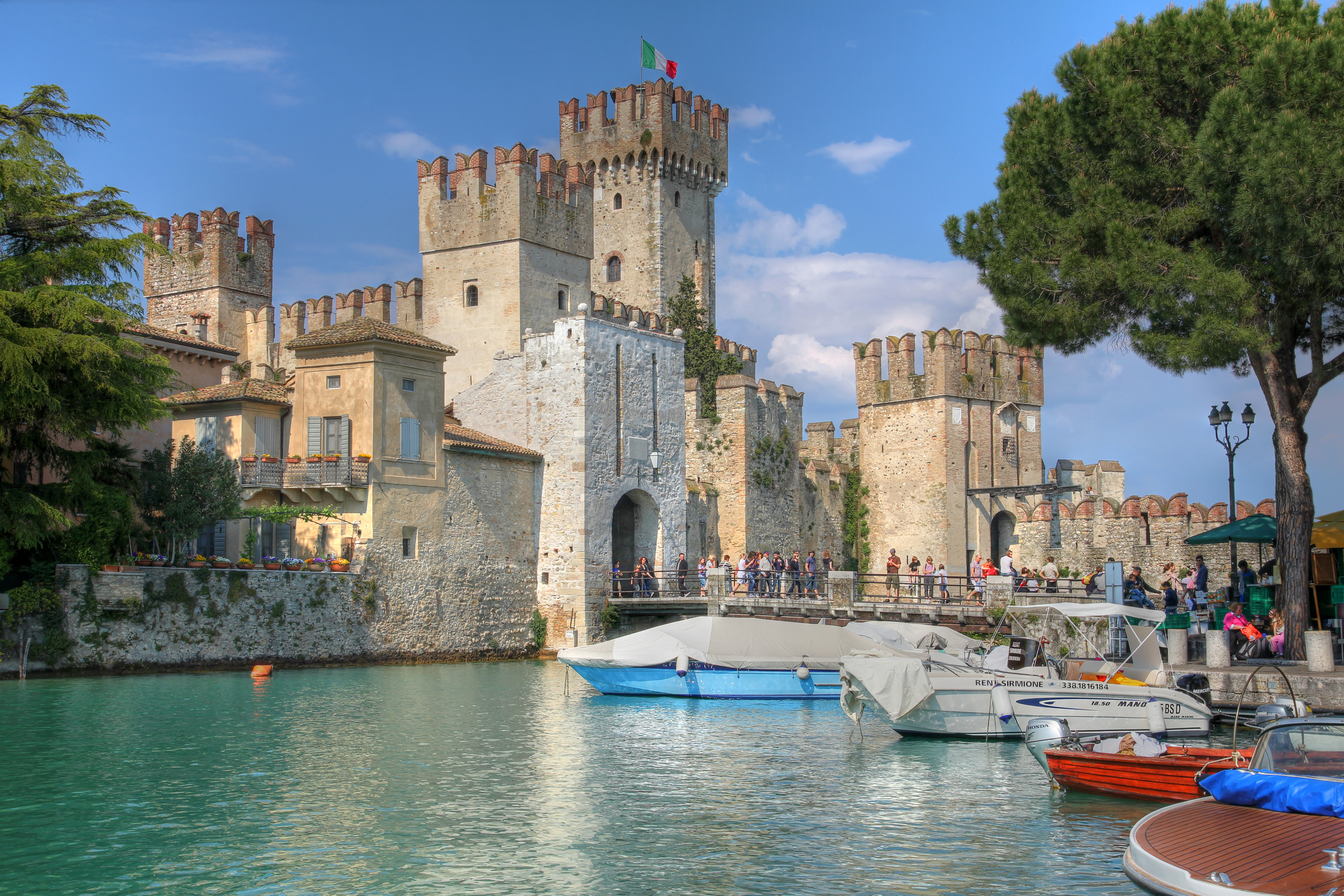 "Sirmione, Italy - April 27th, 2011 - Tourists visiting Scaliger Castle (Castello Scaligero) in Sirmione, on Lake Garda, Italy during spring break."